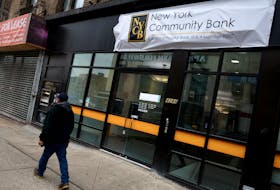A man walks past a closed branch of the New York Community Bank in New York City, U.S., January 31, 2024.