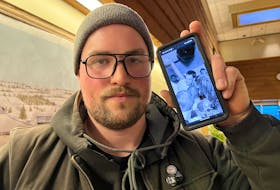 Brett Sanderson holds up his cellphone with one of many pictures of Tyler Jorgensen, who died suddenly on Feb. 1 at the age of 50. Jorgensen was instrumental in establishing a punk rock music scene for the all-ages crowd back in the 1990s that continues today. Dave Stewart • The Guardian