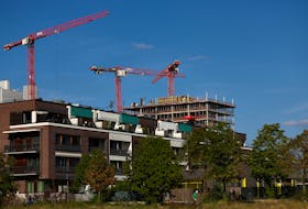 Cranes of a construction site are seen near a residential building, ahead of the summit for affordable housing and construction at the Chancellery in Berlin, Germany September 25, 2023.