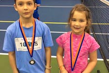 Caden and Joni Colburne, shown in their introduction to tennis at the Cougar Dome in Truro.