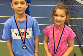 Caden and Joni Colburne, shown in their introduction to tennis at the Cougar Dome in Truro.