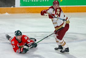 Halifax Mooseheads Jake Todd and Acadie-Bathurst Titan Cory MacGillivray battle for a flying puck during QMJHL action in Halifax Thursday February 29, 2024.

TIM KROCHAK PHOTO