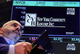A trader works at the post where New York Community Bancorp stock is traded on the floor at the New York Stock Exchange (NYSE) in New York City, U.S., February 7, 2024. 