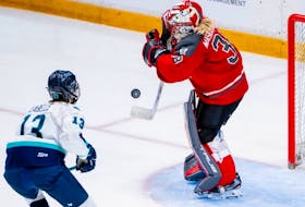 PWHL Ottawa goalie Emerance Maschmeyer (38) blocks a shot as PWHL New York forward Alexandra Labelle (13) reacts during third period of regular season PWHL action in Ottawa, on Wednesday, Feb. 28, 2024.