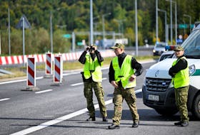 Polish border guards watch for vehicles at the Slovak-Polish border in Zwardon, Poland as part of security measures put in place to detect illegal migrants, October 4, 2023.