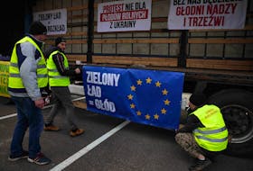 Farmers prepare banners, as they protest at Lithuanian border, alleging Ukrainian grain transports are brought back into Poland as 'EU' grain, and against European Union ‘Green Deal” near border crossing at Polish Lithuanian border in Budzisko, Poland, March 1, 2024.