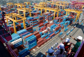 People look at Hanjin Shipping's container terminal at the Busan New Port in Busan, about 420 km (261 miles) southeast of Seoul August 8, 2013. Picture taken August 8, 2013.