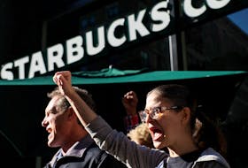 Members of the Starbucks Workers Union and other labor organization picket and hold a rally outside a company owned Starbucks store, during the coffee chain's Red Cup Day event in New York City, U.S., November 16, 2023. 