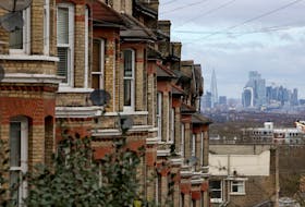 A row of residential houses is seen with the financial district in the distance in South London, Britain, February 26, 2024.