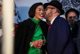 Candidate George Galloway, leader of the Workers Party of Britain, kisses his wife, Putri Gayatri Pertiwi, amidst vote counting during the Rochdale Parliamentary by-election, at a polling station near Manchester, Britain, March 1, 2024.