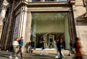 People walk past a Zara shop window at Passeig de Gracia in Barcelona, Spain, December 11, 2023.