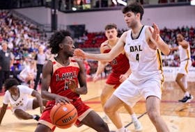 Spencer Riar of the Dalhousie Tigers defends against Laval Rouge et Or's Steeve Joseph during a U Sports Final 8 men's basketball semifinal played Saturday night in Quebec City. - U SPORTS