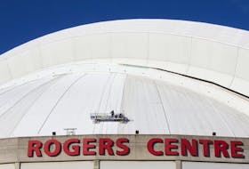 Workmen atop Toronto's Rogers Centre roof on Thursday January 10, 2019. (Stan Behal/Toronto Sun/Postmedia Network)