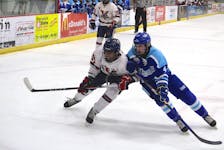 Bage Valley Wildcats forward Jaylen Beals, left, and Steele Subaru defenceman Jake Prince battle for position as they go after the puck during Game 3 of the Nova Scotia Under-18 Major Hockey League semifinal March 14 at the Kings Mutual Century Centre in Berwick.