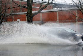 A car jettisons standing water, during an afternoon deluge on Windmill road in Dartmouth Match 7, 2024.

TIM KROCHAK PHOTO