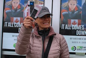 Maggie MacVickar holds up a pair of tickets on Thursday that she bought for the 2024 World Women’s Curling Championship in Sydney. A Team Canada and Rachel Homan fan, she said she's ecstatic the event is in town and that she will likely get more tickets later in the tournament. LUKE DYMENT/CAPE BRETON POST