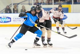 Montreal's Marie-Philip Poulin (right) battles for the puck with Toronto's Renata Fast during the first period of PWHL hockey action in Toronto, on Friday, March 8, 2024.