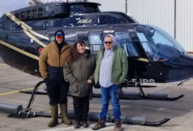 From left, Ayden Pierro, Jennifer Jesty and Noel Herney stand beside a Breton Air helicopter. The three joined Breton Air's Matt Wallace on an aerial search of Eskasoni as part of a recent search for a missing man in the community, the first flight after the partnership announced between Breton Air and Wagmatcook First Nation: 'Kitpu Aviation.' CONTRIBUTED/JENNIFER JESTY