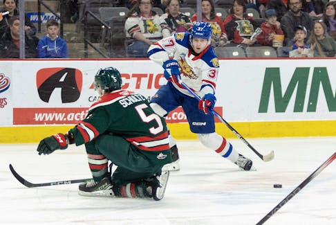 Halifax Mooseheads defenceman Brady Schultz attempts to block a shot by Moncton Wildcats forward Cooper Cormier during a QMJHL game in Moncton on Saturday. - QMJHL