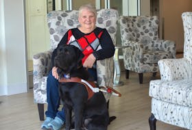 Louise Gillis, 75, with her guide dog Monk in the lobby of their apartment building in Sydney on March 11. NICOLE SULLIVAN/CAPE BRETON POST