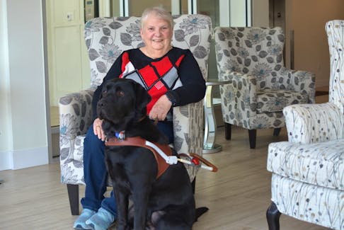 Louise Gillis, 75, with her guide dog Monk in the lobby of their apartment building in Sydney on March 11. NICOLE SULLIVAN/CAPE BRETON POST