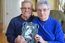 Clair, left, and Shirley Arsenault of Stratford hold a picture of their daughter, Marcia, who was killed by an impaired driver in 1982 when she was 13 years old. Shirley said it’s a hole in her life that has never been filled. Dave Stewart • The Guardian