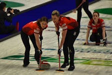 Team Canada’s Sarah Wilkes, left, and Emma Miskew sweep as Tracy Fleury watches her delivery in the background during World Women’s Curling Championship action against Team Norway at Centre 200 in Sydney on Monday. Canada won 9-4. JEREMY FRASER/CAPE BRETON POST