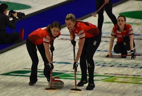 Team Canada’s Sarah Wilkes, left, and Emma Miskew sweep as Tracy Fleury watches her delivery in the background during World Women’s Curling Championship action against Team Norway at Centre 200 in Sydney on Monday. Canada won 9-4. JEREMY FRASER/CAPE BRETON POST