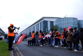 Protestors hold placards during industrial action outside the Amazon warehouse, in Coventry, Britain March 19, 2024.