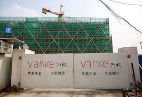 The logo of property developer China Vanke is seen on gates at a construction site in Shanghai, China, March 21, 2017.