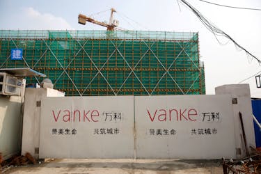 The logo of property developer China Vanke is seen on gates at a construction site in Shanghai, China, March 21, 2017.