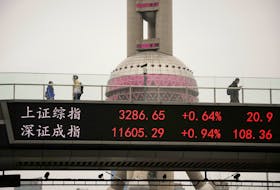An electronic board shows Shanghai and Shenzhen stock indexes at the Lujiazui financial district in Shanghai, China, March 24, 2023.