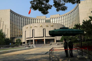 Paramilitary police officers stand guard in front of the headquarters of the People's Bank of China, the central bank (PBOC), in Beijing, China September 30, 2022.