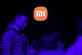Attendees arrive before a Xiaomi event on the company's first electric vehicle, the SU7, in Beijing, China December 28, 2023.