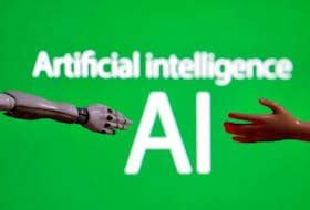 Words reading "Artificial intelligence AI", miniature of robot and toy hand are pictured in this illustration taken December 14, 2023.