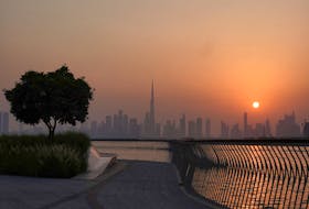 The Burj Khalifa building peaks through the skyline as the sun sets over Dubai, United Arab Emirates, September 9, 2023.