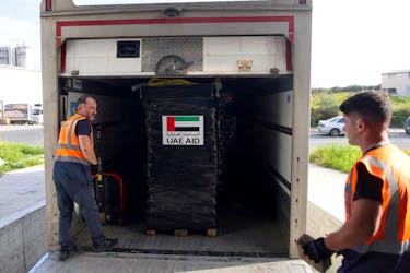 Workers load a track with humanitarian aid gathered by World Central Kitchen and planned to be shipped to Gaza, in a warehouse in Larnaca, Cyprus March 13, 2024.