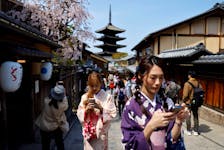 A crowd of tourists walk on the street near Kiyomizu-dera temple in Kyoto, western Japan March 30, 2023. 