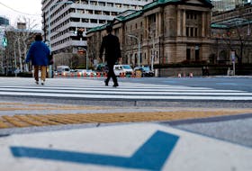 People walk in front of the Bank of Japan building in Tokyo, Japan January 23, 2024.