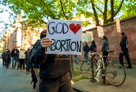 A person holds a sign during an abortion rights counter protest in response to a monthly demonstration by members of the Catholic Church where they march from St. Patrick's Basilica to Planned Parenthood one block away in New York City, U.S., May 6, 2023.