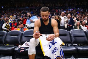 Stephen Curry #30 of the Golden State Warriors signs his jersey after their NBA game against the Toronto Raptors at Scotiabank Arena on March 1, 2024 in Toronto. 