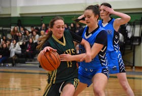 Jorja Walker of the Memorial Marauders, left, works her way to the basket as she's challenged by Sarah MacLeod of the North Nova Gryphons during School Sport Nova Scotia Division 1 girls' basketball provincial championship action at Memorial High School in Sydney Mines on Friday. North Nova won the game 68-29. JEREMY FRASER/CAPE BRETON POST
