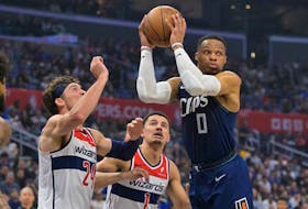 Mar 1, 2024; Los Angeles, California, USA; Los Angeles Clippers guard Russell Westbrook (0) passes the ball as he is defended by Washington Wizards forward Corey Kispert (24) and guard Johnny Davis (1) in the first half at Crypto.com Arena. Mandatory Credit: Jayne Kamin-Oncea-USA TODAY Sports
