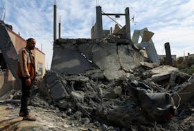 A Palestinian man stands at the site of an Israeli strike on a house, amid the ongoing conflict between Israel and Hamas, in Rafah in the southern Gaza Strip, March 1, 2024.