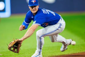 Matt Chapman of the Blue Jays can't catch up to a line drive during a game against the Cleveland Guardians at Rogers Centre on August 26, 2023 in Toronto.