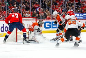 Mar 1, 2024; Washington, District of Columbia, USA; Philadelphia Flyers goaltender Samuel Ersson (33) makes a save on Washington Capitals right wing Tom Wilson (43) in the first period at Capital One Arena. Mandatory Credit: Geoff Burke-USA TODAY Sports