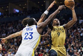 Raptors' RJ Barrett, right, drives against Draymond Green of the Warriors during first half NBA action at Scotiabank Arena in Toronto, Friday, March 1, 2024.
