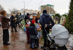 People come to the grave of Russian opposition politician Alexei Navalny the day after his funeral at the Borisovskoye cemetery in Moscow, Russia, March 2, 2024.
