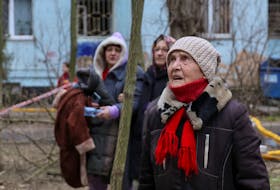 Residents look at their apartment building heavily damaged by a Russian drone strike, amid Russia's attack on Ukraine, in Odesa, Ukraine March 2, 2024.