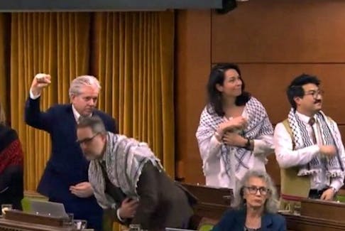 An image from the House of Commons live feed taken as members rose to vote on a Monday motion to recognize Palestinian statehood. While political props are technically banned in the House of Commons, several NDPers wore keffiyeh, a scarf popularized as a symbol of armed Palestinian resistance. 